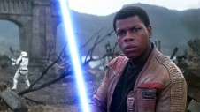 John Boyega as Finn with a lightsaber in Star Wars
